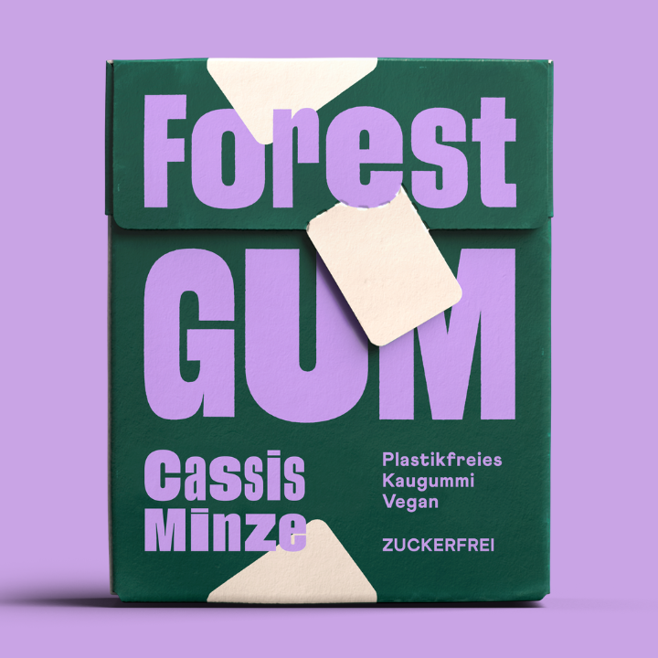 Forest Gum Cassis Minze nachhaltiger Kaugummi in FSC Papier Flipbox, zuckerfrei & plastikfrei, vor Lila Hintergrund.